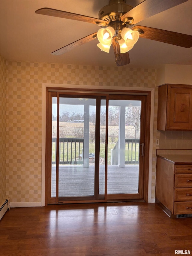 entryway with wood-type flooring and ceiling fan