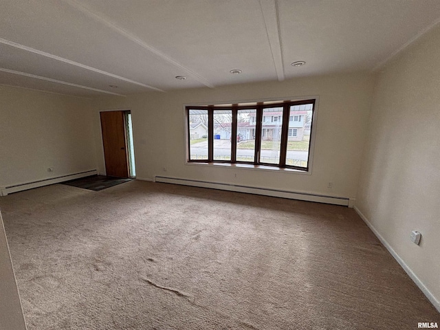 carpeted spare room featuring baseboard heating