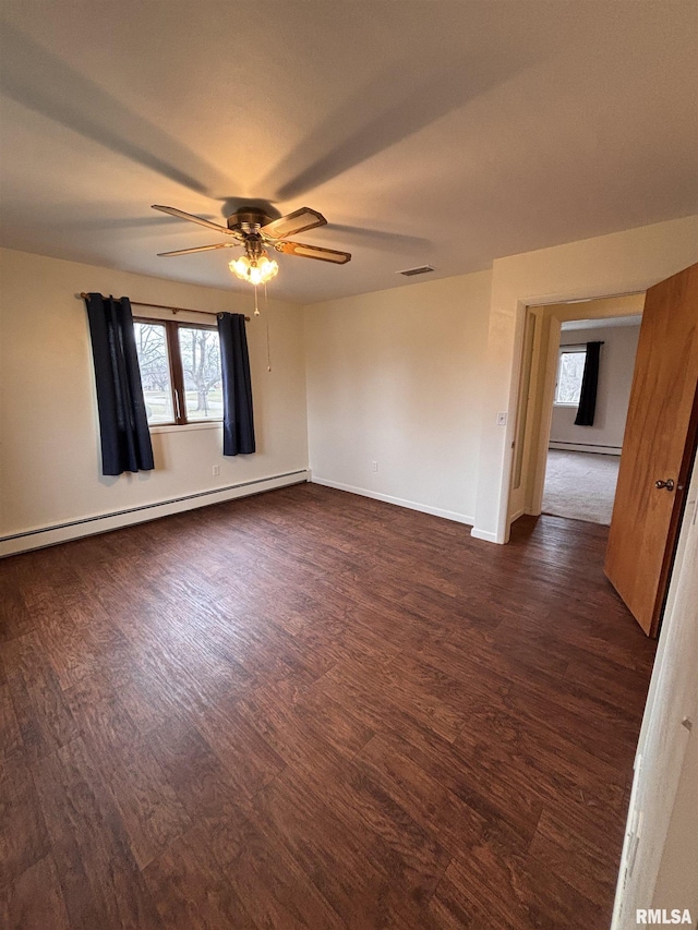 unfurnished room with ceiling fan, a baseboard heating unit, and dark hardwood / wood-style floors