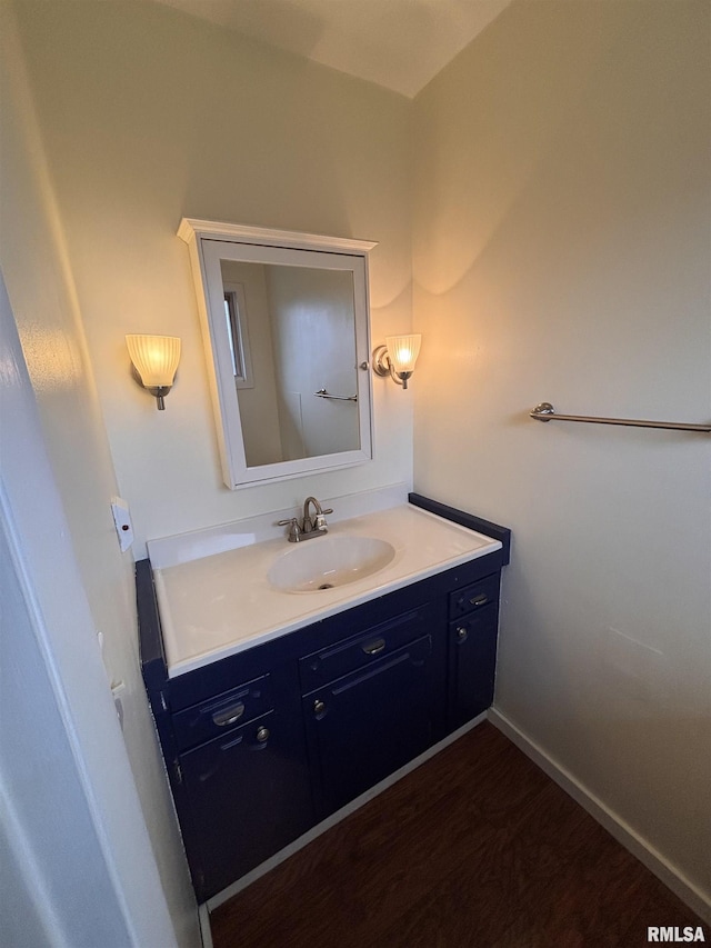 bathroom featuring hardwood / wood-style flooring and vanity