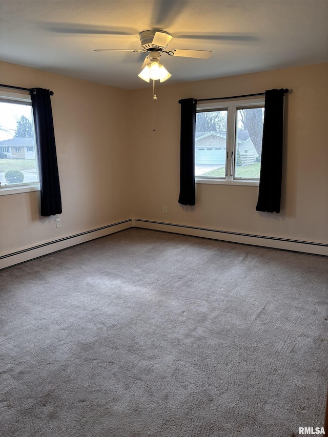 empty room with plenty of natural light, carpet floors, and ceiling fan