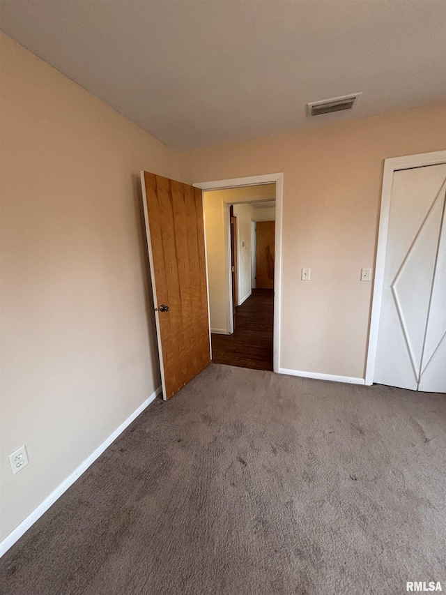 unfurnished bedroom featuring dark carpet