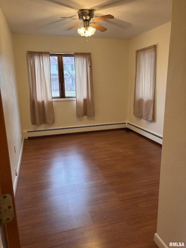 spare room with dark wood-type flooring and ceiling fan