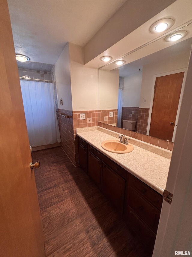 bathroom featuring hardwood / wood-style floors, vanity, tile walls, and toilet