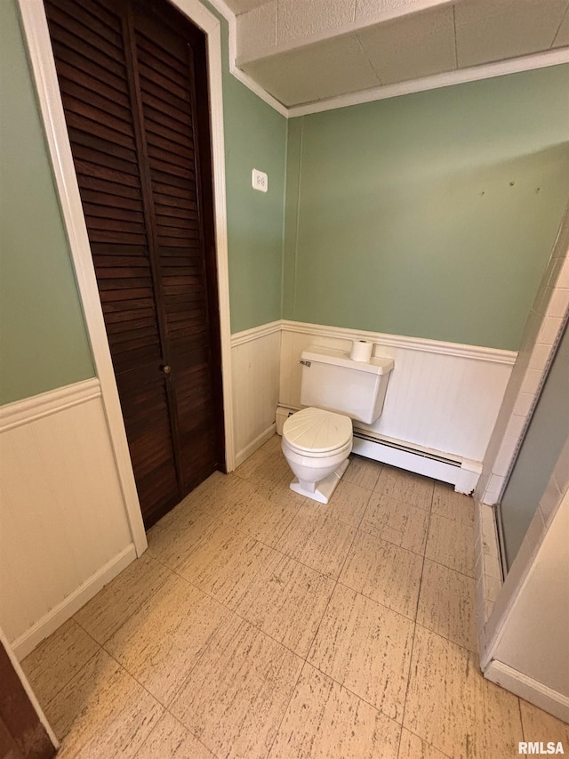 bathroom featuring a baseboard radiator and toilet