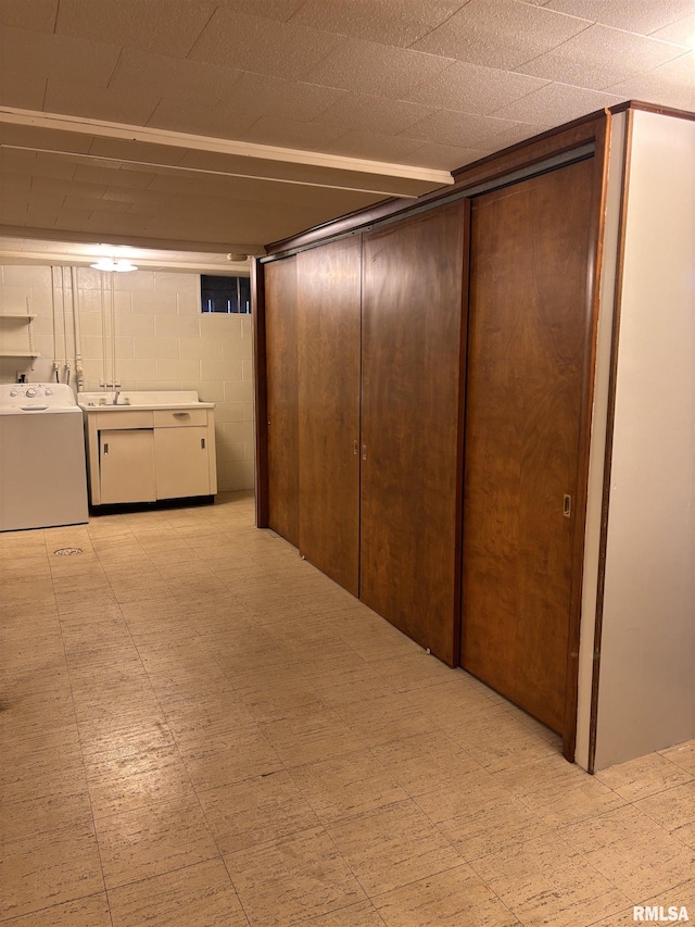 basement featuring sink and washer and clothes dryer