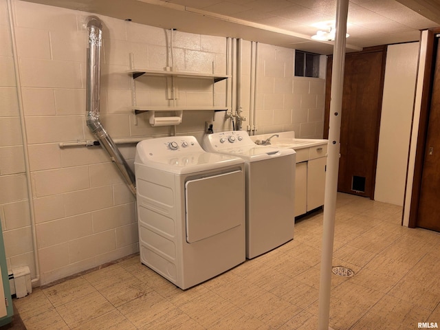 laundry room with cabinets, a baseboard radiator, and washer and dryer