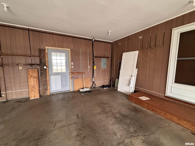 garage with wooden walls and electric panel