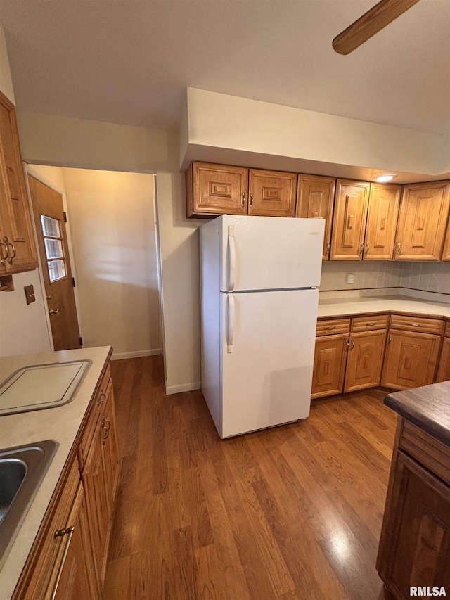 kitchen featuring sink, wood-type flooring, ceiling fan, and white fridge