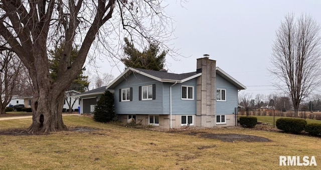 view of side of property with a garage and a lawn