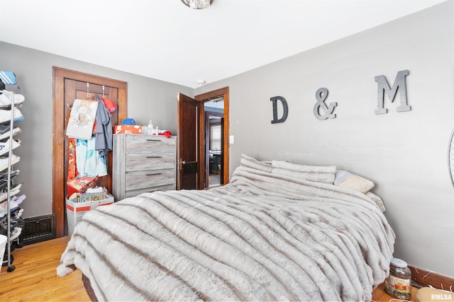 bedroom with hardwood / wood-style flooring