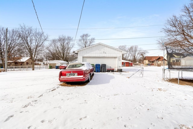 snow covered property with a trampoline