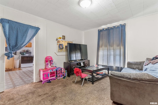 carpeted living room featuring ornamental molding