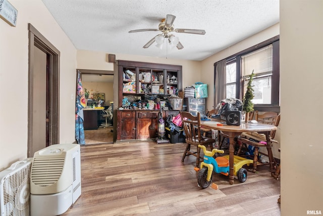 office area with ceiling fan, wood-type flooring, and a textured ceiling