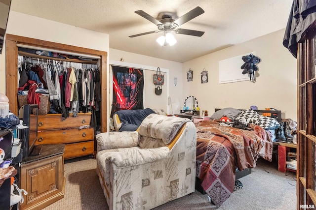 carpeted bedroom with a textured ceiling, ceiling fan, and a closet