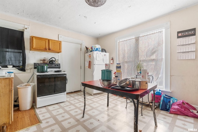 kitchen with a textured ceiling and white appliances