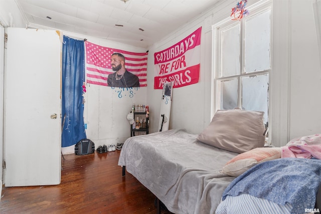 bedroom with dark hardwood / wood-style floors