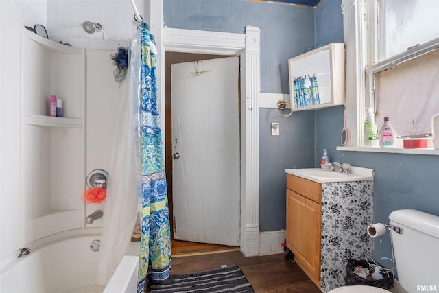 full bathroom featuring vanity, hardwood / wood-style flooring, shower / bath combination with curtain, and toilet