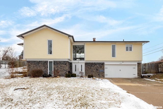 view of front of house featuring a garage and a balcony