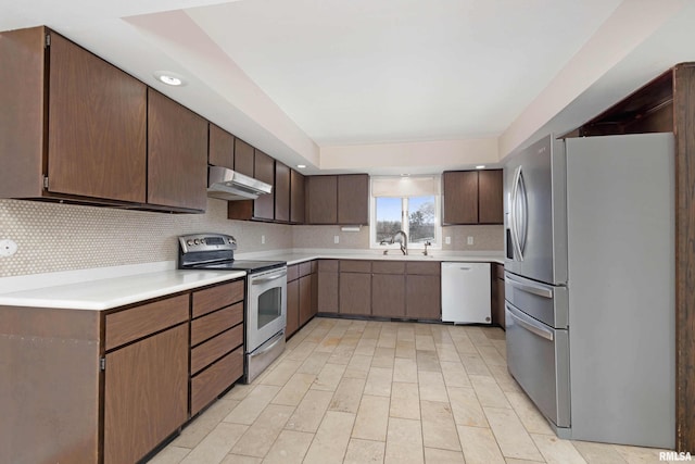 kitchen with backsplash, dark brown cabinets, stainless steel appliances, and sink