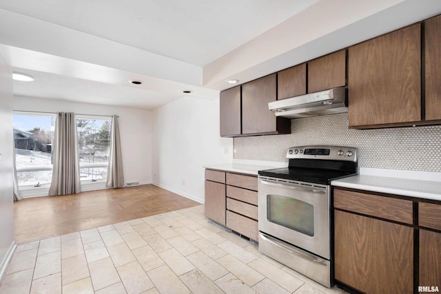 kitchen with tasteful backsplash and stainless steel range with electric cooktop