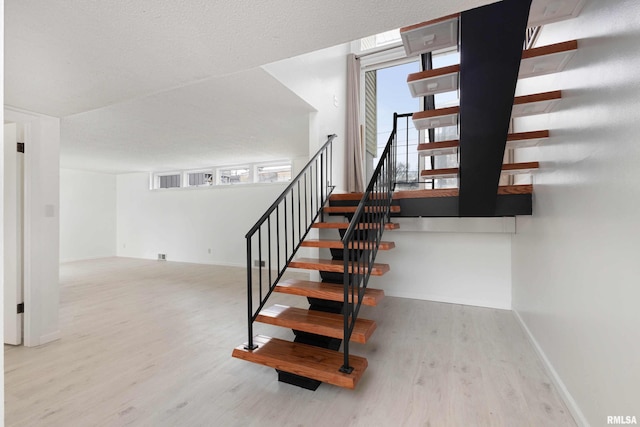 staircase featuring hardwood / wood-style floors