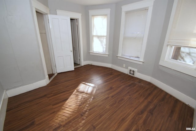 unfurnished bedroom with dark hardwood / wood-style floors