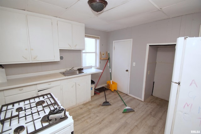 kitchen with white cabinetry, sink, a paneled ceiling, and white appliances