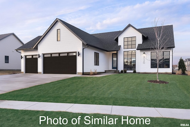 modern inspired farmhouse featuring a garage and a front yard