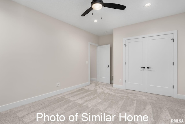 unfurnished bedroom featuring light colored carpet, ceiling fan, and a closet