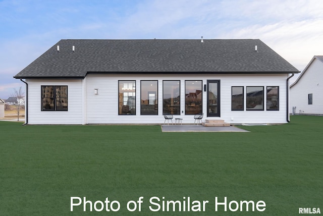 back house at dusk featuring a yard and a patio area