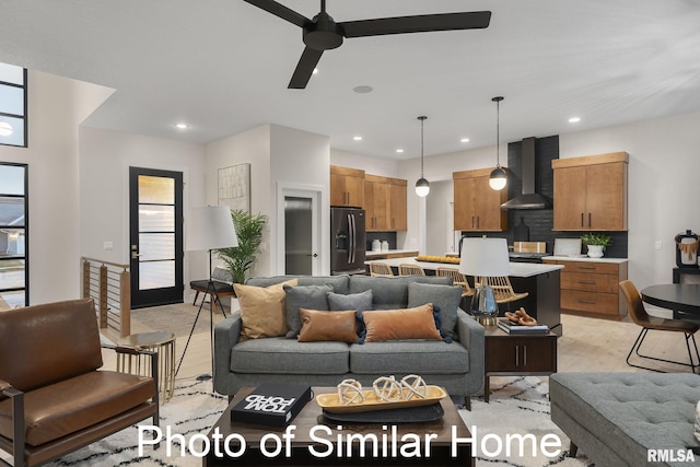 living room with ceiling fan and light hardwood / wood-style flooring