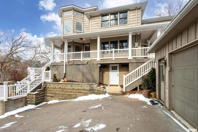 view of front of house featuring a porch and a garage