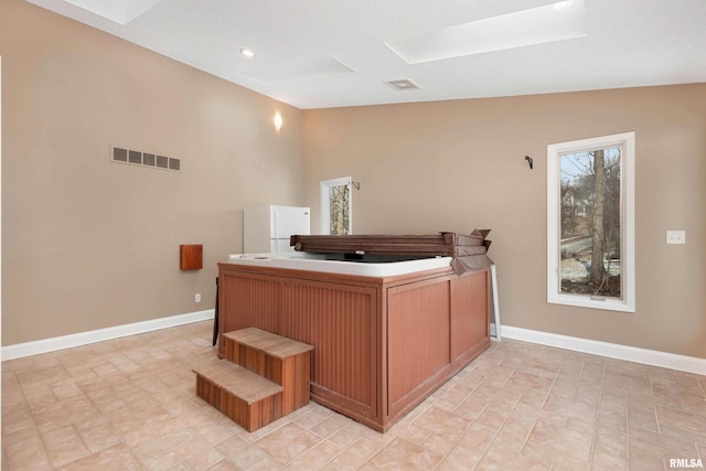 office featuring vaulted ceiling with skylight