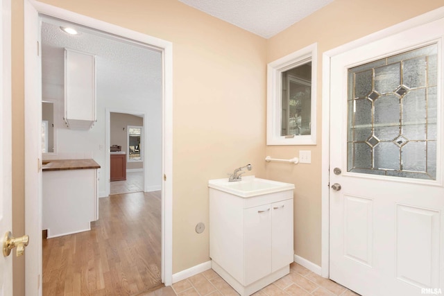 bathroom featuring tile patterned floors, a textured ceiling, and vanity