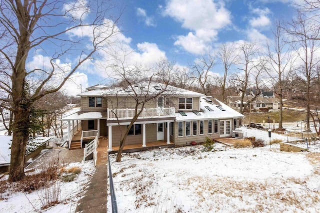 view of snow covered back of property