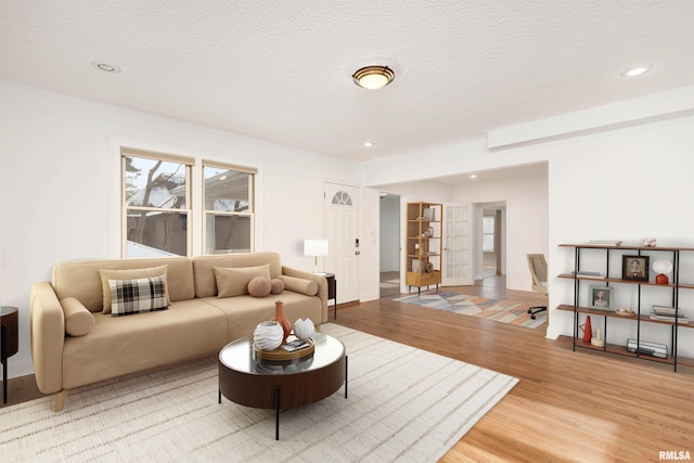 living room featuring hardwood / wood-style flooring and a textured ceiling