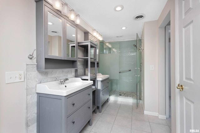 bathroom with vanity, an enclosed shower, and tile patterned flooring