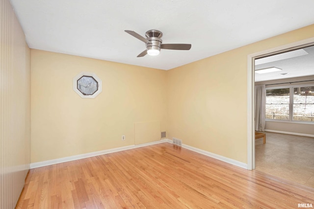 empty room with light hardwood / wood-style flooring and ceiling fan