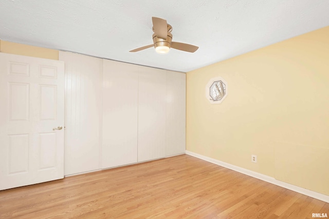 unfurnished bedroom with a closet, ceiling fan, and light hardwood / wood-style floors