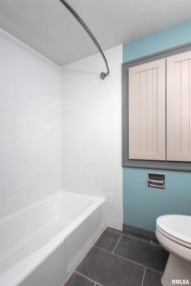 bathroom with toilet, bathtub / shower combination, and tile patterned flooring