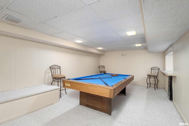 recreation room with a paneled ceiling, billiards, and wooden walls