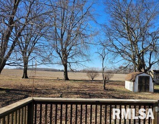 view of yard with a rural view and a storage unit