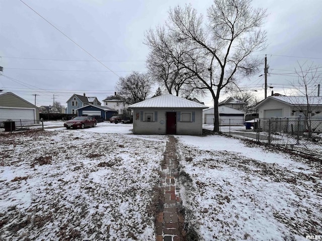 yard layered in snow featuring an outbuilding