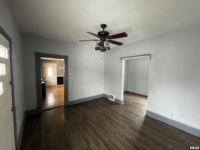 empty room featuring dark hardwood / wood-style floors and ceiling fan