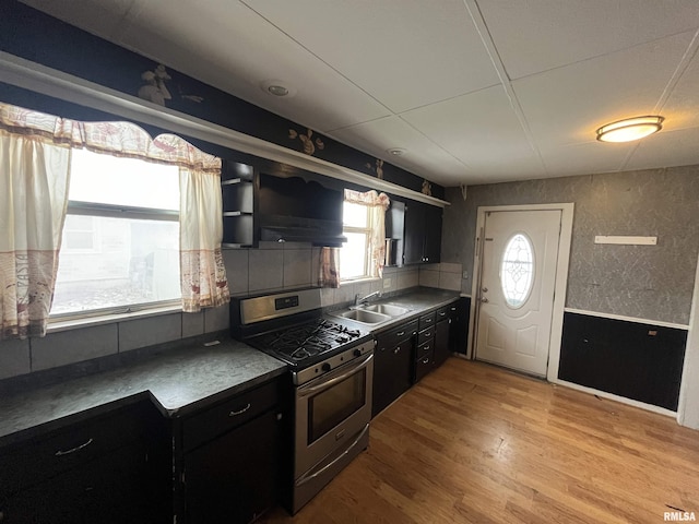 kitchen with stainless steel gas range, sink, and light wood-type flooring