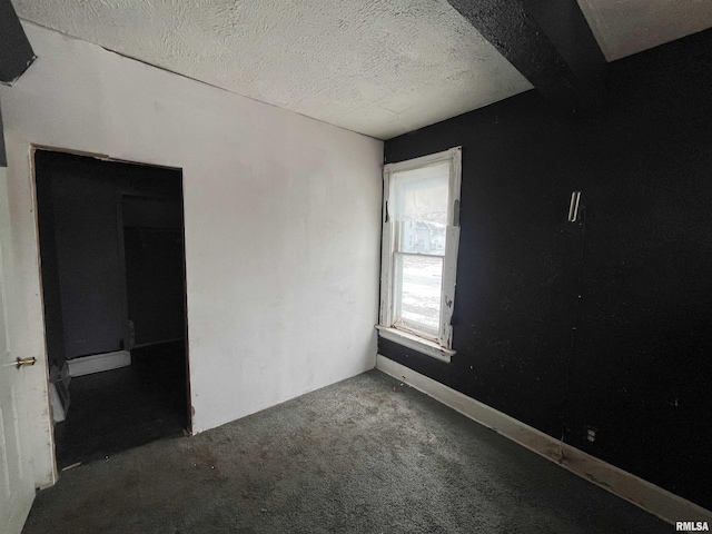 carpeted spare room with a textured ceiling