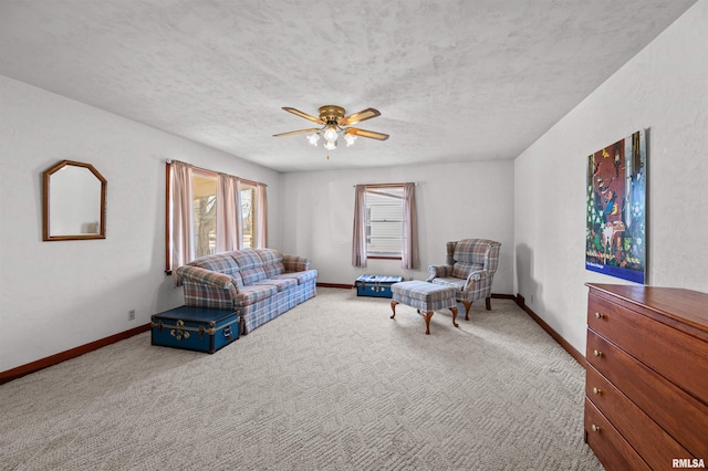 carpeted living room featuring a textured ceiling and ceiling fan