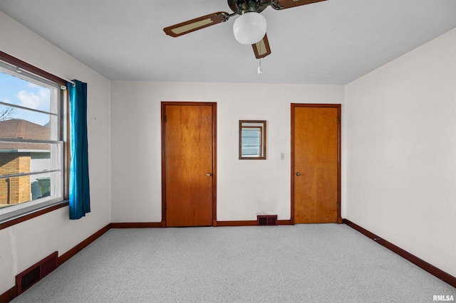 unfurnished bedroom featuring ceiling fan and light colored carpet