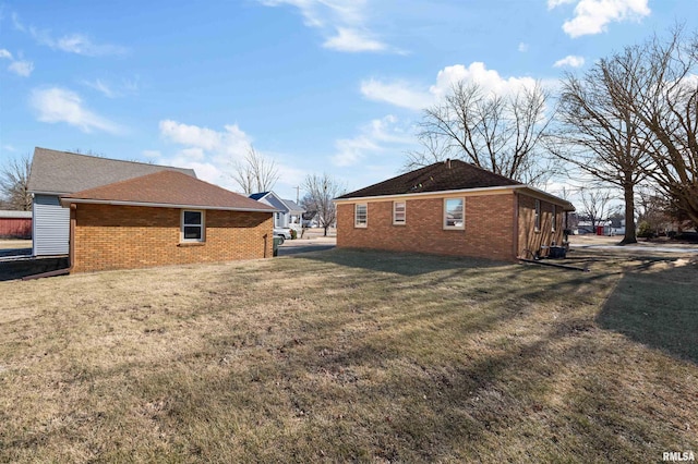 view of side of home featuring a yard